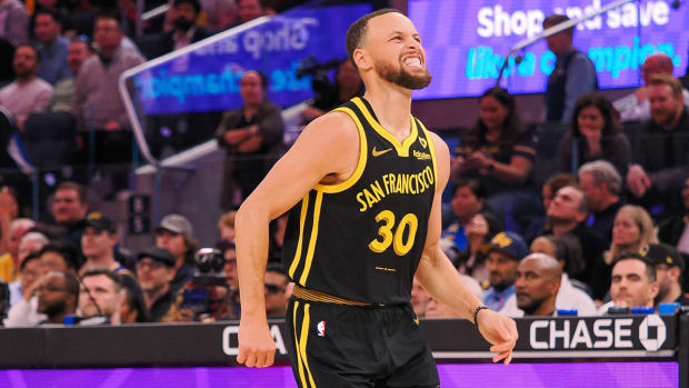 Steph Curry hobbles off the court after suffering an ankle injury.